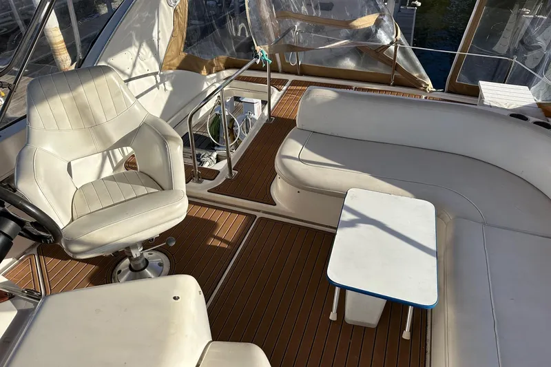 Slide: The Image of Interior of 2003 Meridian 381 Sedan yacht with white seating and wooden flooring. - 8