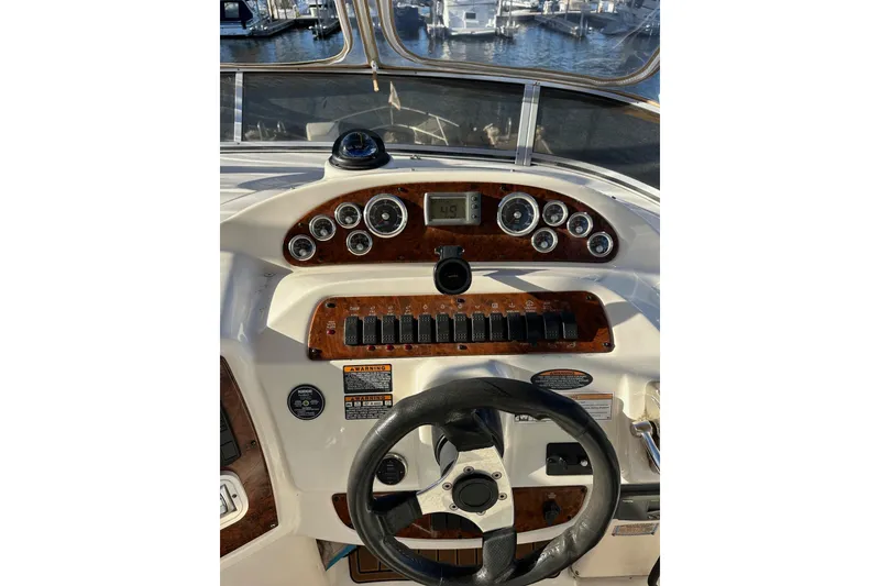 Slide: The Image of Dashboard of a 2003 Meridian 381 Sedan boat with gauges and steering wheel. - 9