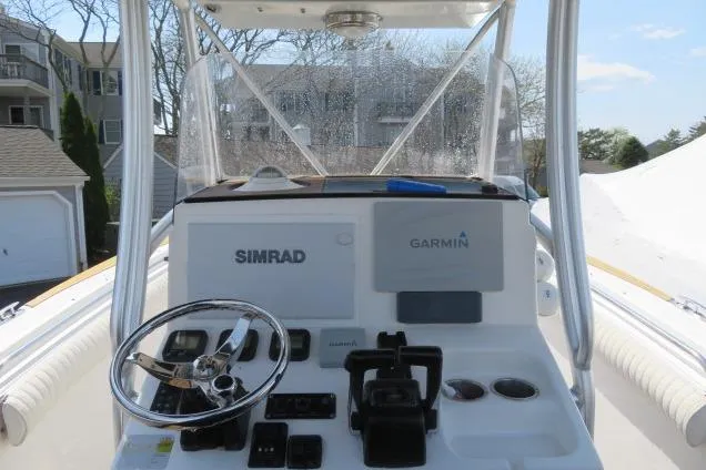 Slide: The Image of 2006 Sea Hunt Triton 260 boat dashboard with Simrad and Garmin navigation systems. - 13