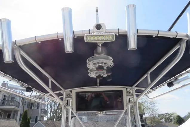 Slide: The Image of T-top of 2006 Sea Hunt Triton 260 boat with rod holders and electronics. - 14