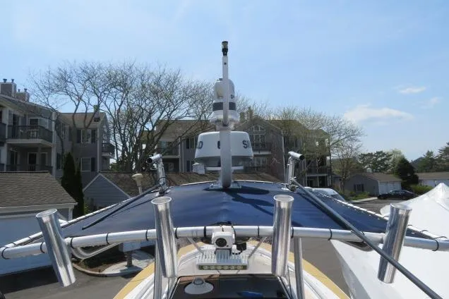 Slide: The Image of 2006 Sea Hunt Triton 260 boat with radar and rod holders, docked near residential buildings. - 16