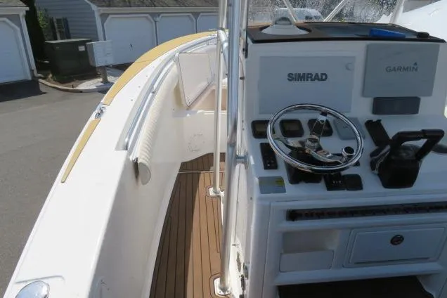 Slide: The Image of 2006 Sea Hunt Triton 260 boat cockpit with Simrad and Garmin navigation systems. - 19