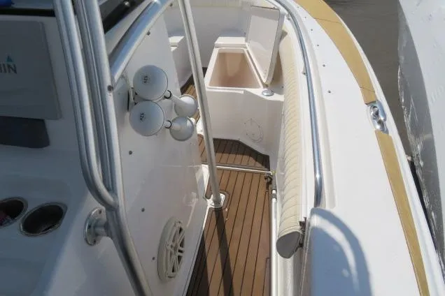 Slide: The Image of 2006 Sea Hunt Triton 260 boat interior with seating and storage compartments. - 23