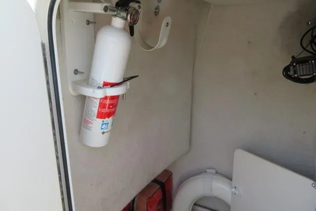 Slide: The Image of Fire extinguisher mounted inside 2006 Sea Hunt Triton 260 boat cabin. - 25