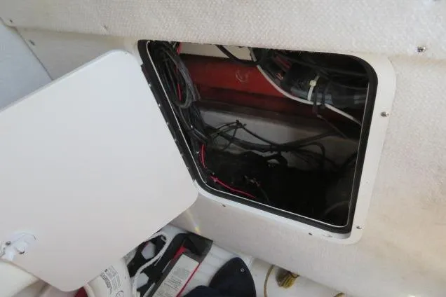 Slide: The Image of Open hatch with wiring inside a 2006 Sea Hunt Triton 260 boat. - 28