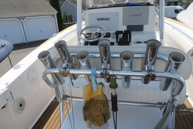 Slide: The Image of 2006 Sea Hunt Triton 260 boat cockpit with rod holders and navigation equipment. - 32