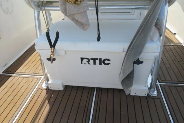 Slide: The Image of RTIC cooler on 2006 Sea Hunt Triton 260 boat deck with teak flooring. - 33