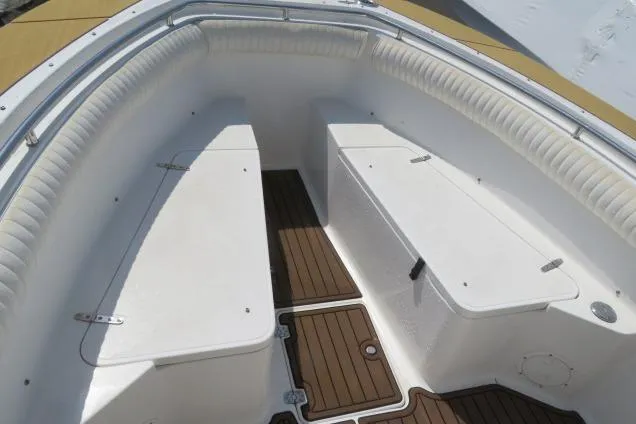 Slide: The Image of 2006 Sea Hunt Triton 260 boat interior with cushioned seating and wooden flooring. - 39