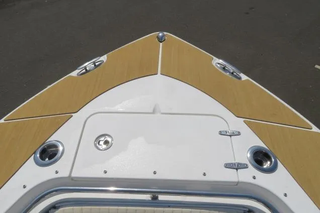 Slide: The Image of Bow of 2006 Sea Hunt Triton 260 boat with tan and white deck. - 42