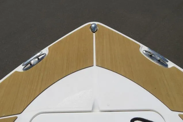 Slide: The Image of Bow of 2006 Sea Hunt Triton 260 boat with cleats and wood finish. - 43