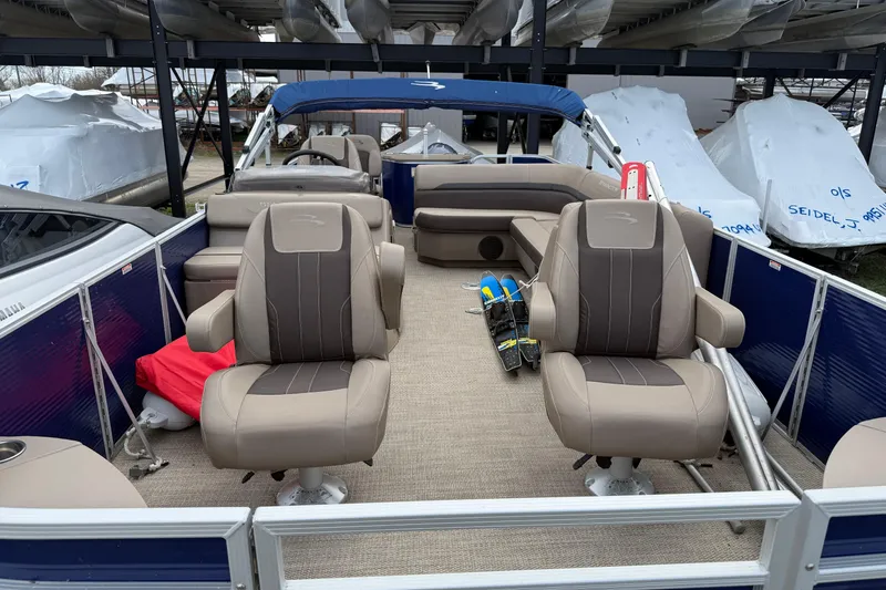 Slide: The Image of 2020 Bennington SX22 pontoon boat interior with beige seating and blue accents. - 3