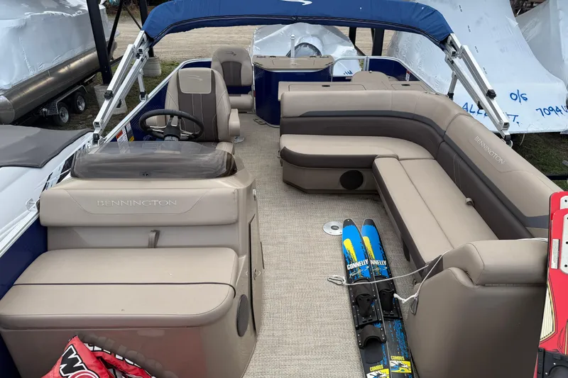 Slide: The Image of 2020 Bennington SX22 pontoon boat interior with beige seating and water skis. - 4