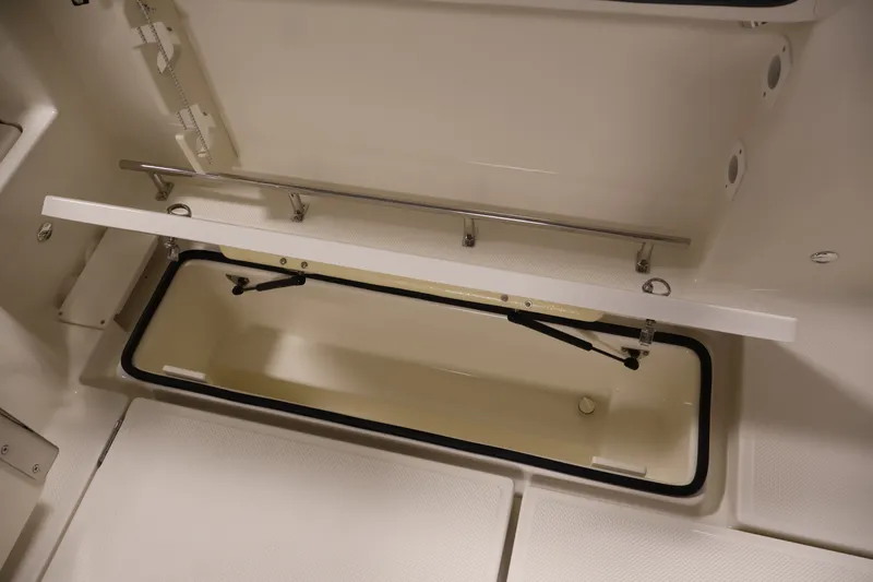 Slide: The Image of Open storage compartment in 2026 Bayliner Trophy T25 Pilothouse boat interior. - 65
