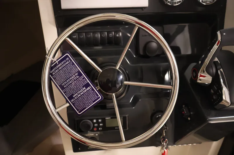 Slide: The Image of Steering wheel and controls of 2026 Bayliner Trophy T25 Pilothouse boat. - 41
