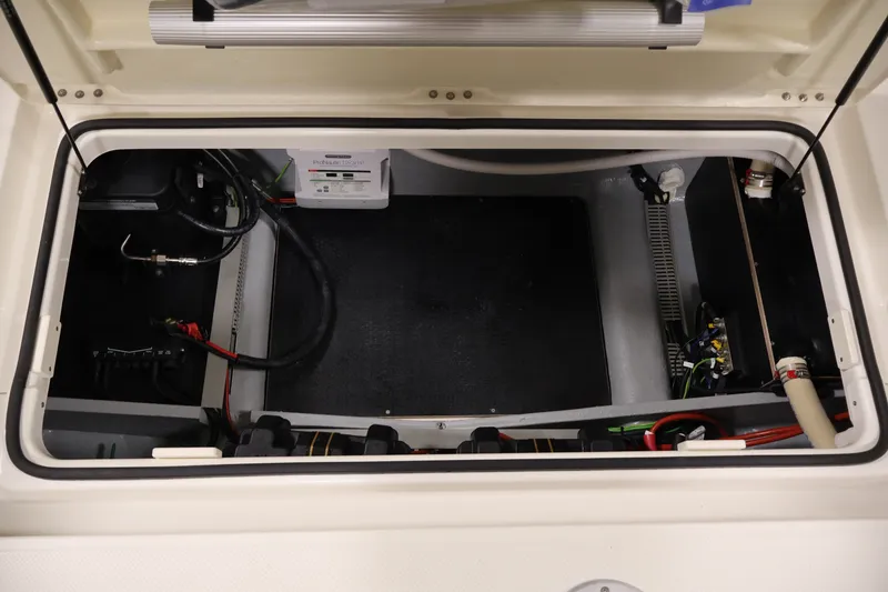 Slide: The Image of 2026 Bayliner Trophy T25 Pilothouse engine compartment with wiring and components visible. - 64