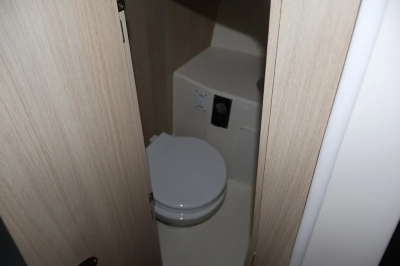 Slide: The Image of 2026 Bayliner Trophy T25 Pilothouse bathroom interior with compact toilet design. - 61