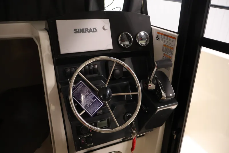 Slide: The Image of 2026 Bayliner Trophy T25 Pilothouse helm with Simrad navigation system and steering wheel. - 40