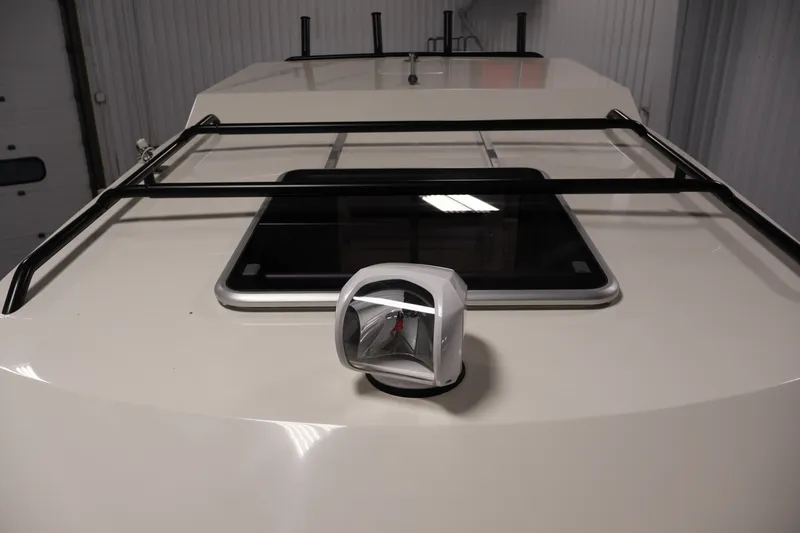 Slide: The Image of 2026 Bayliner Trophy T25 Pilothouse roof with mounted light and railing. - 34