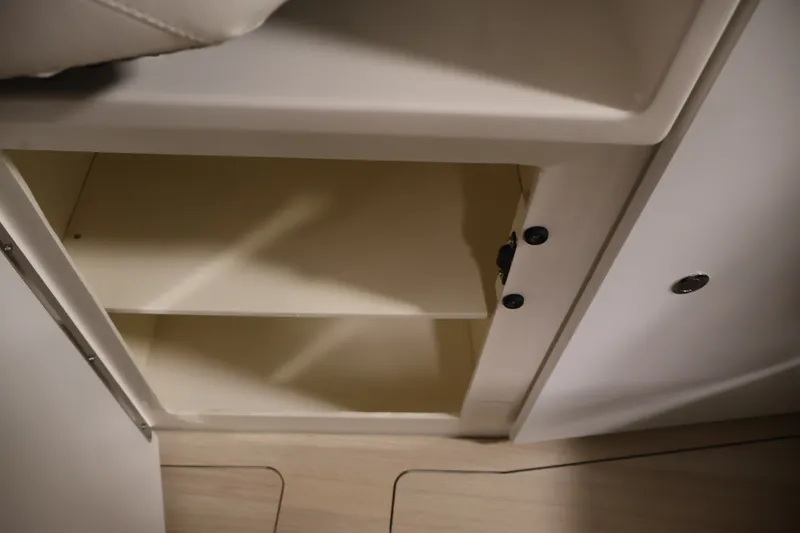 Slide: The Image of Open storage cabinet inside 2026 Bayliner Trophy T25 Pilothouse boat. - 57