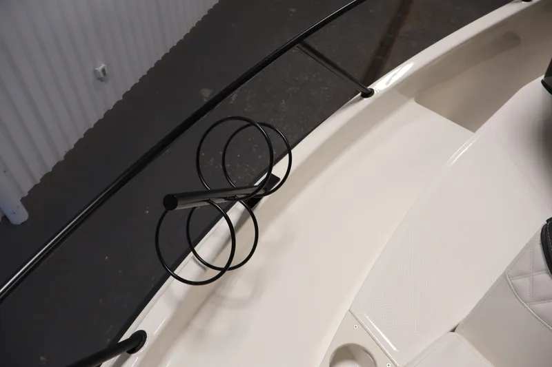 Slide: The Image of 2026 Bayliner Trophy T25 Pilothouse boat interior with rod holders and seating detail. - 35