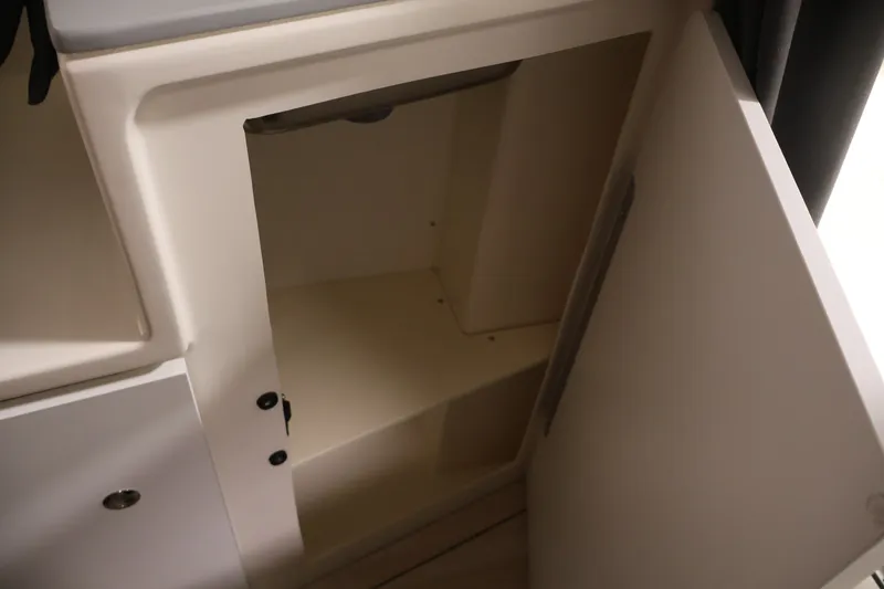 Slide: The Image of Open storage compartment in 2026 Bayliner Trophy T25 Pilothouse boat interior. - 58