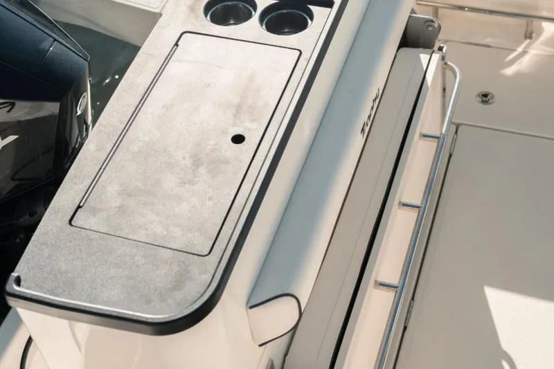 Slide: The Image of 2026 Bayliner Trophy T25 Pilothouse boat deck with storage and cup holders. - 6