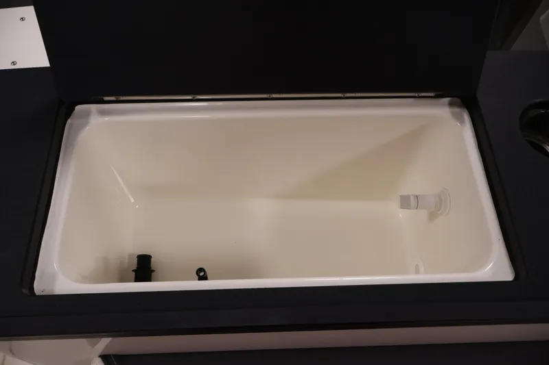 Slide: The Image of 2026 Bayliner Trophy T25 Pilothouse interior storage compartment, open and empty. - 68