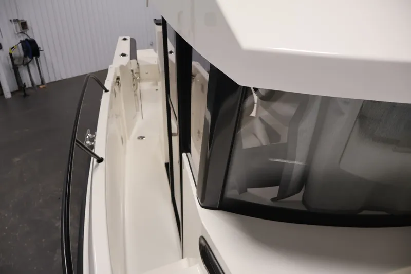 Slide: The Image of 2026 Bayliner Trophy T25 Pilothouse boat, side view with sleek design and modern windows. - 37