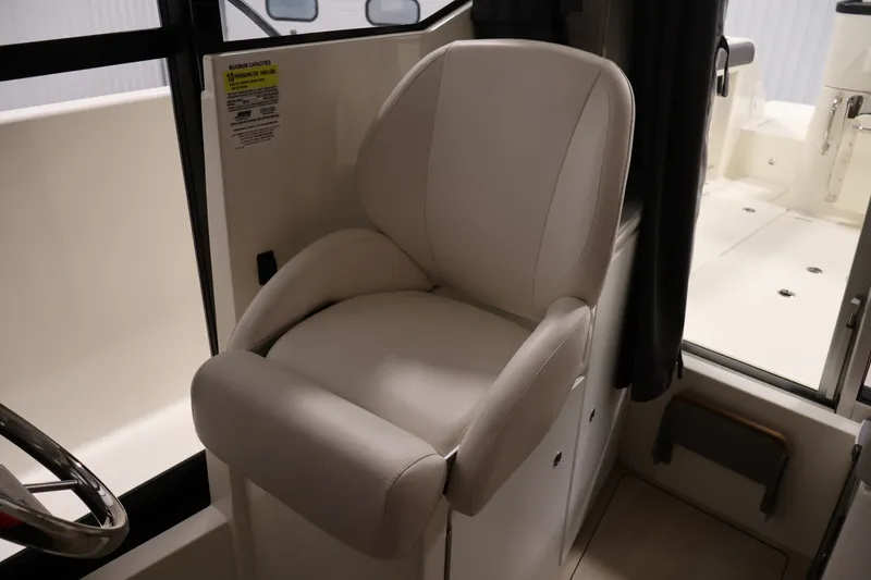 Slide: The Image of 2026 Bayliner Trophy T25 Pilothouse interior with a comfortable captain's chair. - 53