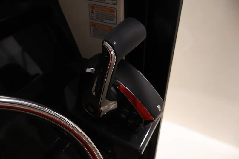 Slide: The Image of Throttle control of 2026 Bayliner Trophy T25 Pilothouse boat, featuring sleek design and ergonomic handle. - 49