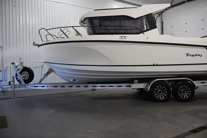 Slide: The Image of 2026 Bayliner Trophy T25 Pilothouse boat on trailer in indoor storage. - 78