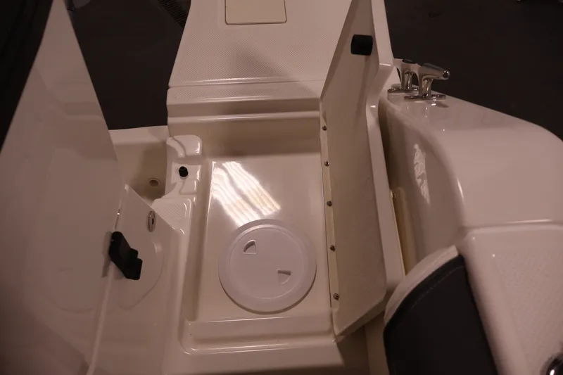 Slide: The Image of 2026 Bayliner Trophy T25 Pilothouse storage compartment with open hatch and latch. - 70