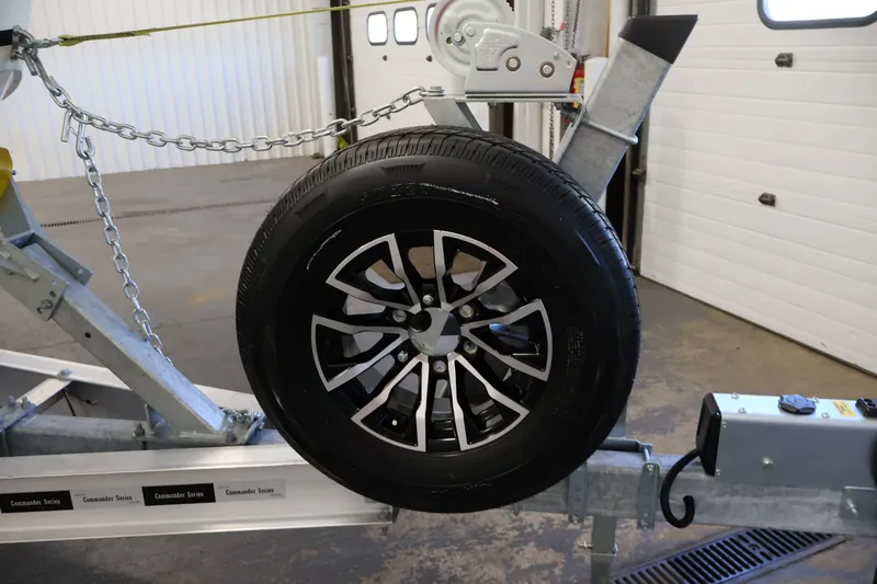 Slide: The Image of Trailer wheel for 2026 Bayliner Trophy T25 Pilothouse in a garage setting. - 77