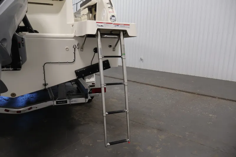Slide: The Image of 2026 Bayliner Trophy T25 Pilothouse boat with extended ladder on trailer. - 75