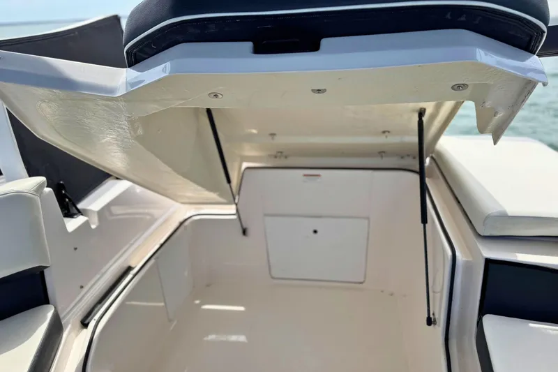 Slide: The Image of 2019 Regal 21 OBX boat storage compartment with open hatch, showcasing spacious interior. - 13