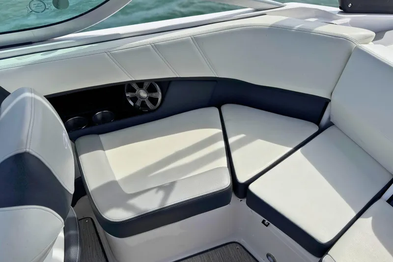Slide: The Image of 2019 Regal 21 OBX boat interior with cushioned seating and speaker. - 15