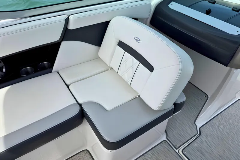 Slide: The Image of 2019 Regal 21 OBX boat interior with white and gray seating, cup holders, and sleek design. - 19