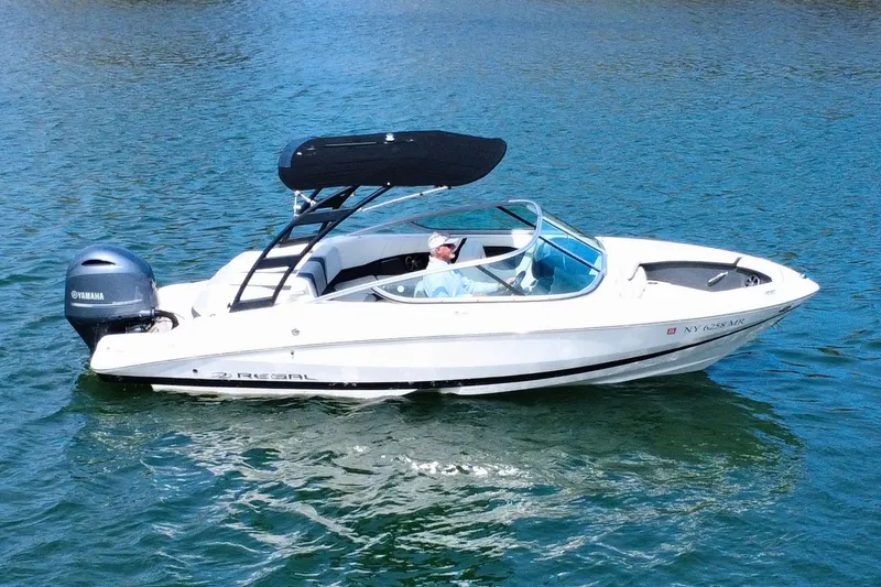 Slide: The Image of 2019 Regal 21 OBX boat with Yamaha engine on a calm lake. - 2