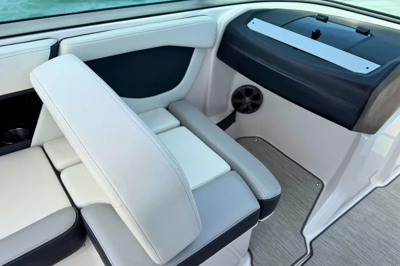 Slide: The Image of Interior seating of a 2019 Regal 21 OBX boat with white and gray upholstery. - 20
