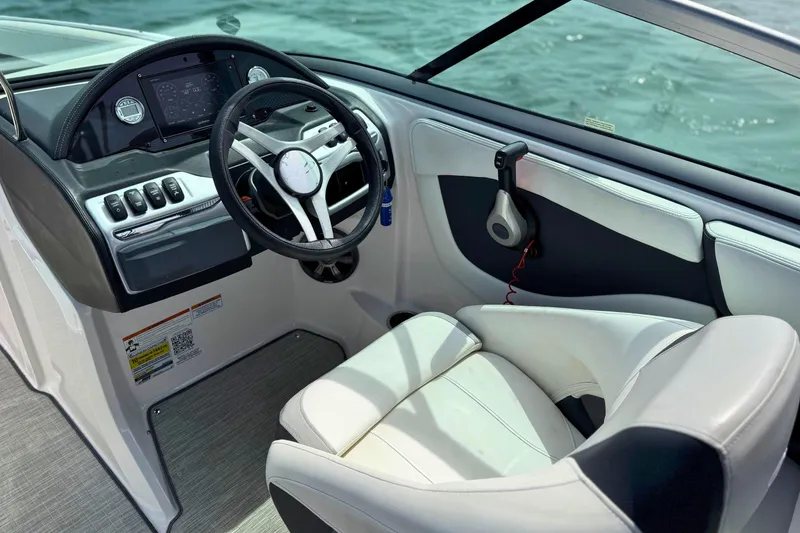 Slide: The Image of 2019 Regal 21 OBX boat interior with steering wheel and control panel. - 22