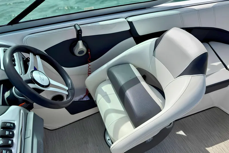 Slide: The Image of 2019 Regal 21 OBX boat interior with steering wheel and cushioned seating. - 24