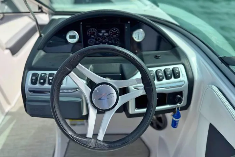 Slide: The Image of Steering wheel and dashboard of a 2019 Regal 21 OBX boat. - 25