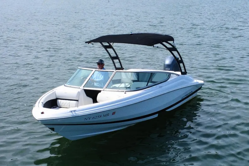 Slide: The Image of 2019 Regal 21 OBX boat on water with a person onboard, featuring a sleek design. - 3