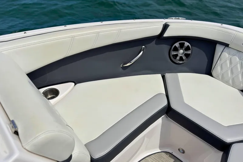 Slide: The Image of Luxurious seating area on 2019 Regal 21 OBX boat with cup holder and speaker. - 32