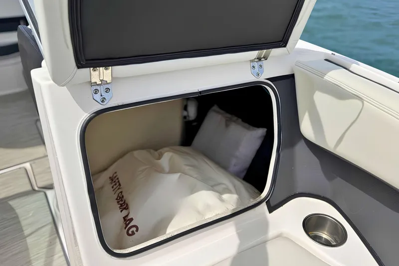 Slide: The Image of 2019 Regal 21 OBX boat storage compartment with safety bag inside. - 33