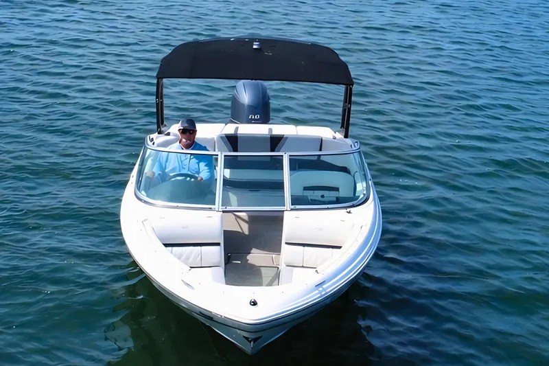 Slide: The Image of 2019 Regal 21 OBX boat cruising on calm blue water. - 6
