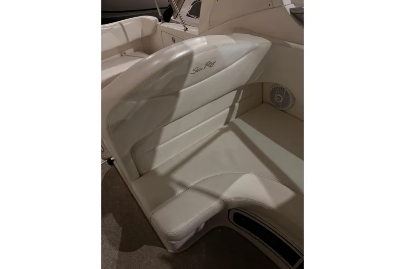 Slide: The Image of 2004 Searay 280 Sundancer boat interior seating with logo and speaker. - 10