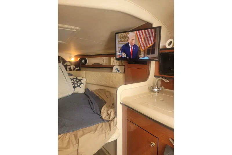 Slide: The Image of Interior of 2004 Searay 280 Sundancer with bed, TV, and sink. - 11