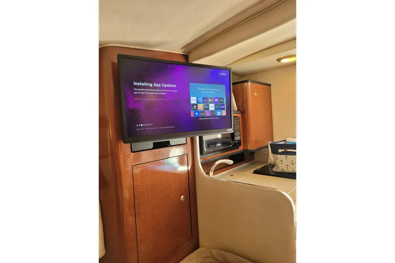 Slide: The Image of Interior of 2004 Searay 280 Sundancer with TV displaying app updates. - 12