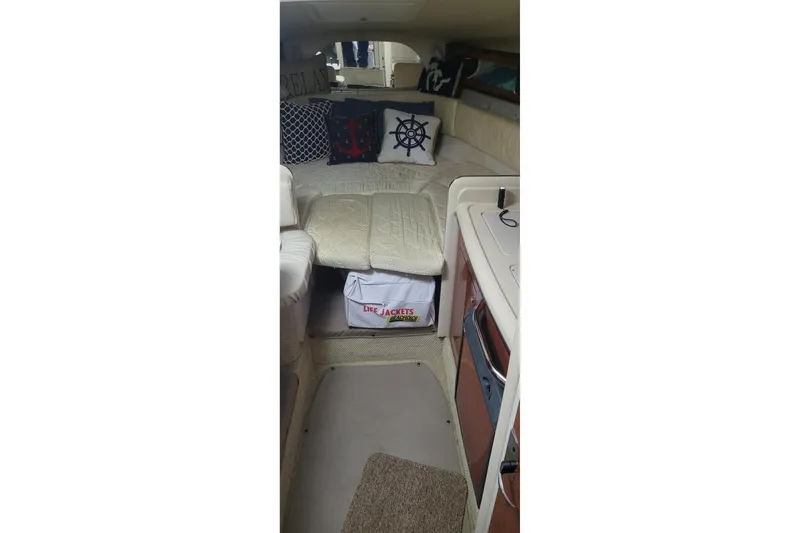 Slide: The Image of Interior of 2004 Sea Ray Sundancer 280 with cozy seating and nautical-themed decor. - 28